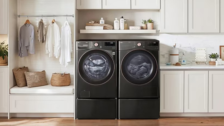 black steel LG washer and dryer in a white laundry room