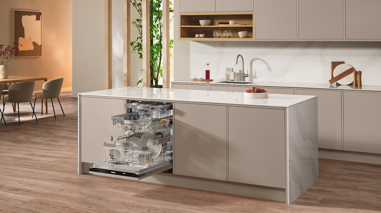 modern kitchen with Miele panel ready dishwasher open on island