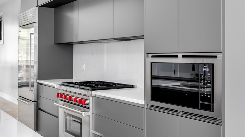 kitchen with Sub-Zero/Wolf appliances, including the range's signature red knobs