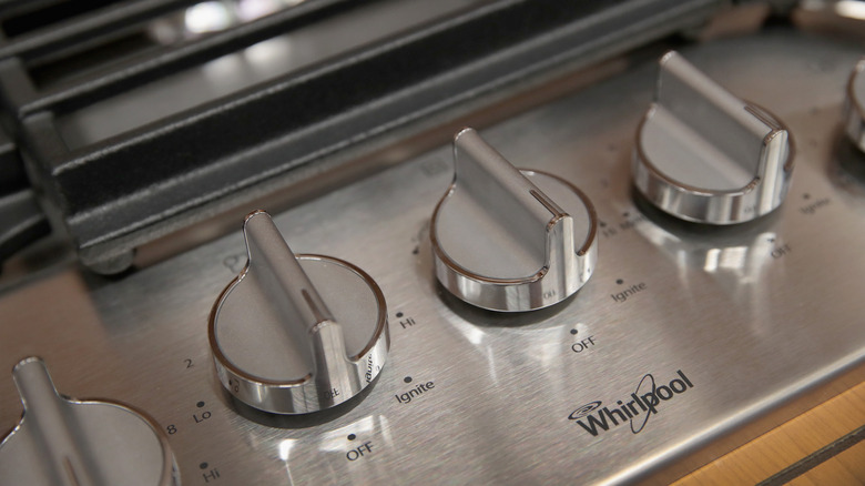 range knobs with Whirlpool appliances logo