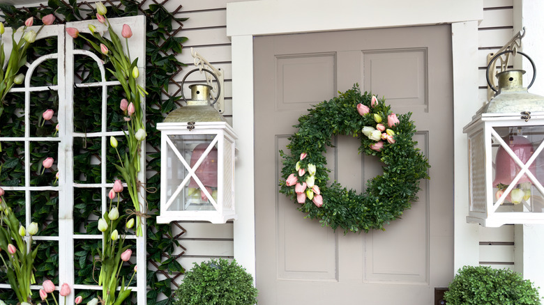 Front door with spring wreath and decor.