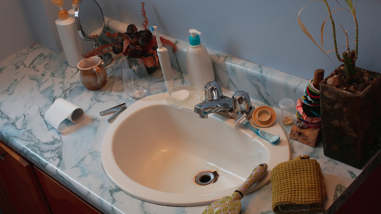 items strewn across bathroom counter