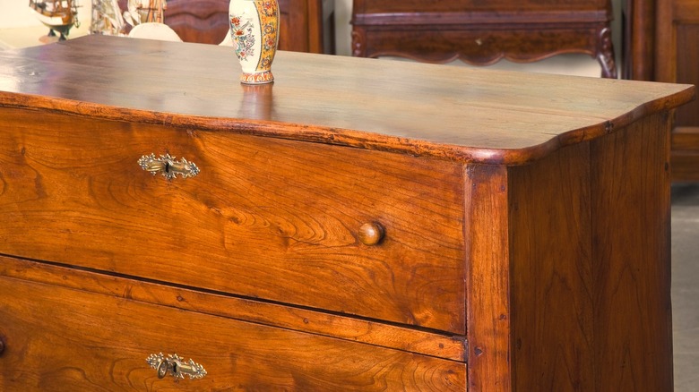 Wooden dresser with an old-fashioned orange-hued color