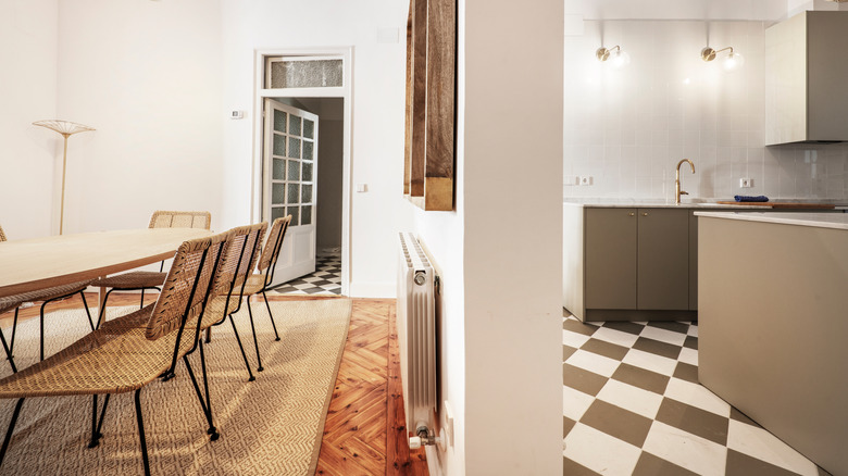 A dining room and kitchen separated by a wall