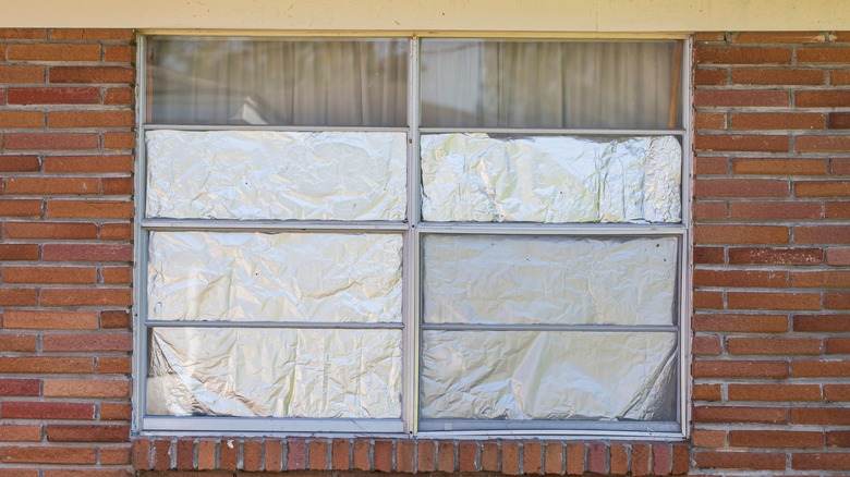Exterior view of foil-covered windows on brick building
