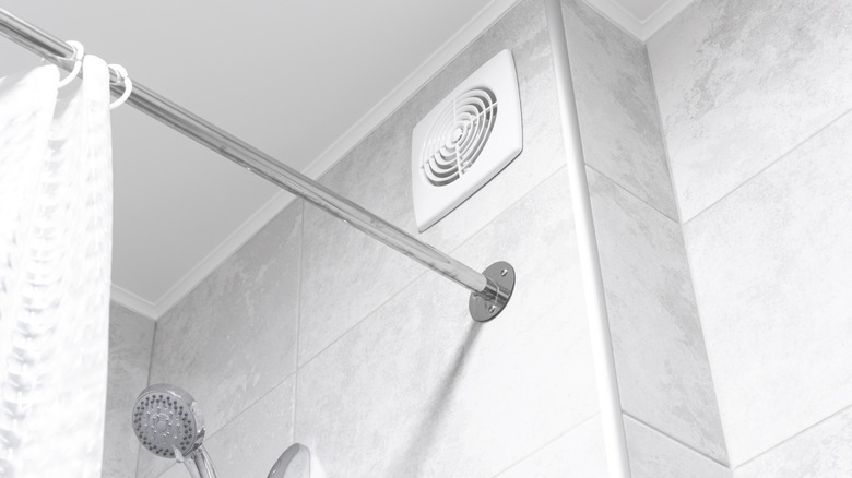 Bathroom exhaust fan on tiled wall