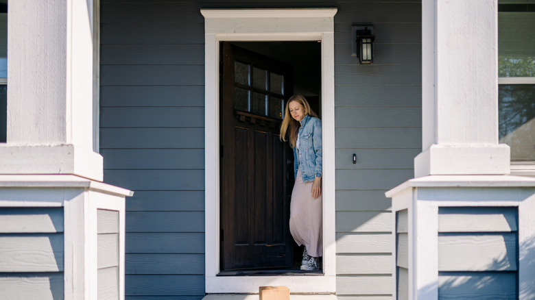 Woman in the front door by her porch