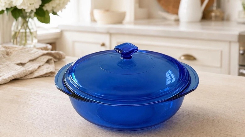 A vintage cobalt blue Pyrex casserole dish on a counter.
