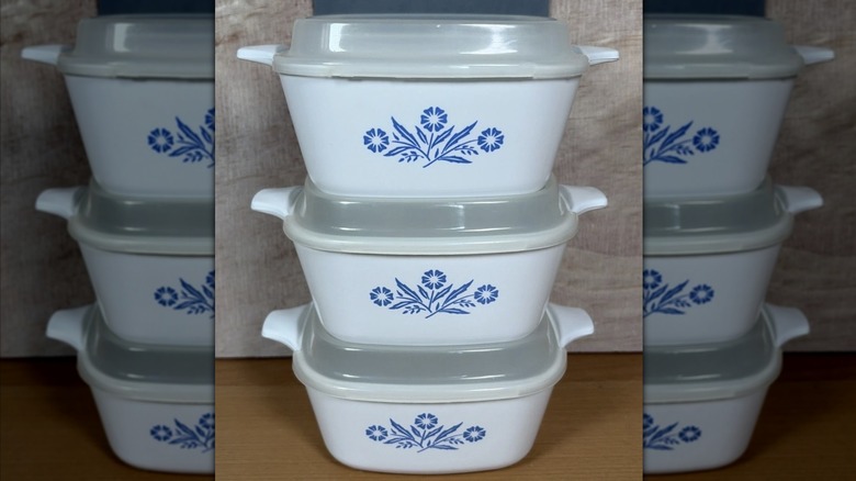 A stack of three CoringWare blue cornfield casserole dishes on top of each other on a kitchen counter