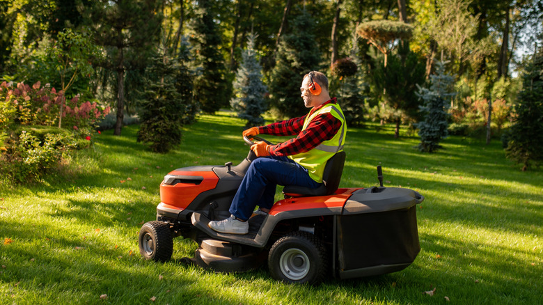 Man riding a lawn mower.