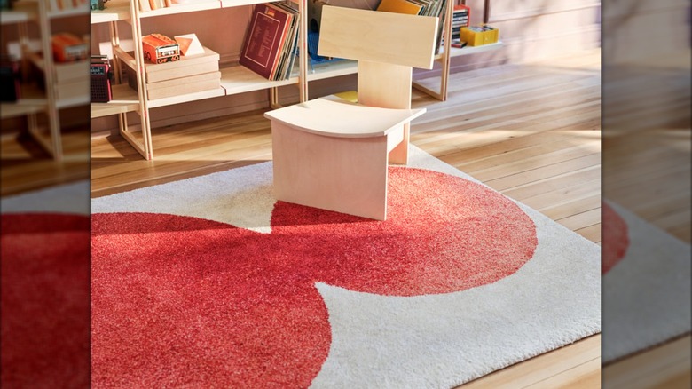 A modern wooden chair sits on the IKEA PS 2026 rug