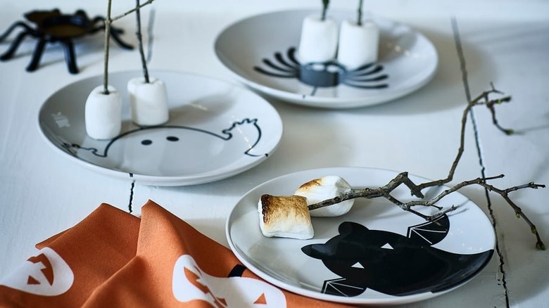 Marshmallows rest on three Halloween-themed plates