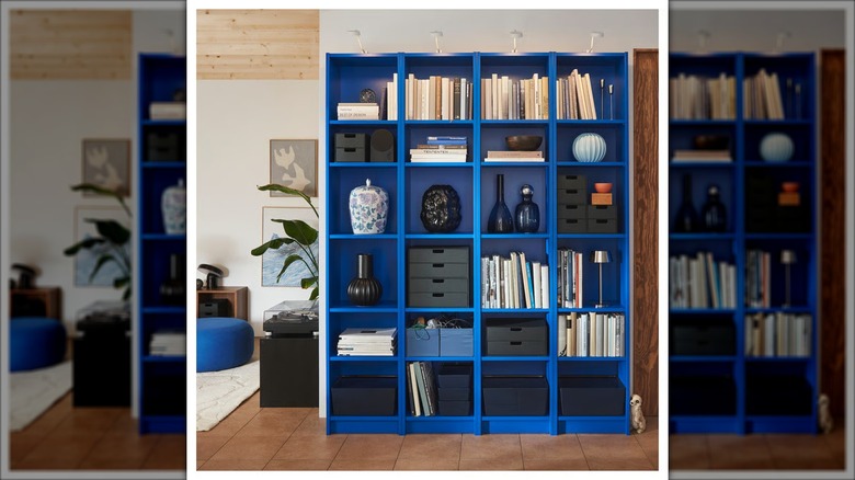 A row of bright blue BILLY bookcases full of books and decorative items.
