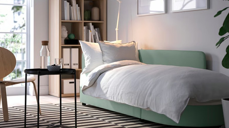 A LINDÅKRA sleeper sofa made up as a bed.