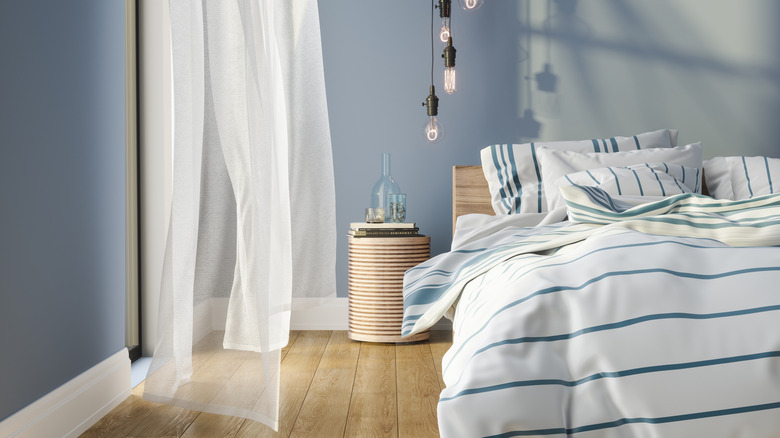 Bedroom with a muted, soft blue walls.