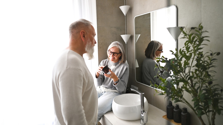 Couple sitting in a bathroom near the vanity