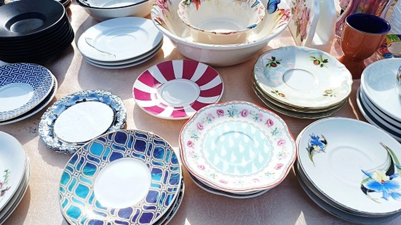 Vintage dishes for sale at an outdoor market.