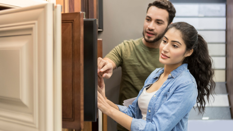 A couple looks at cabinet door samples