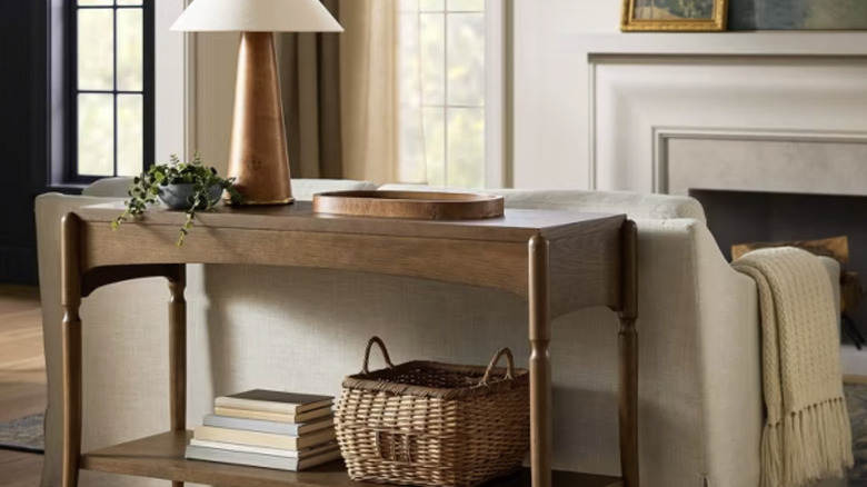Wooden console table from Target behind a couch