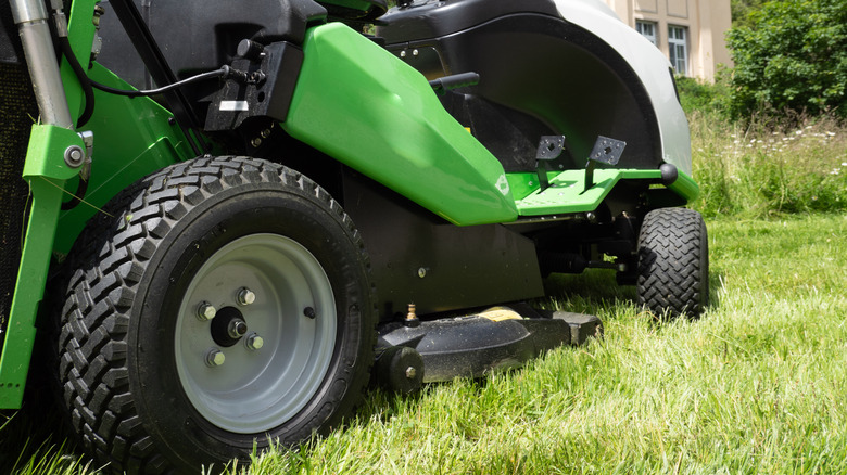 wheels of a green riding mower