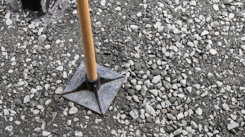 tool for tamping gravel flat and firm