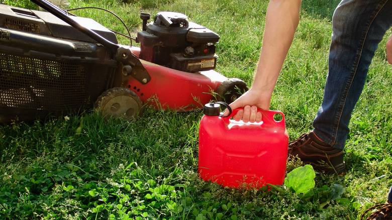 gasoline bottle next to a lawn mower