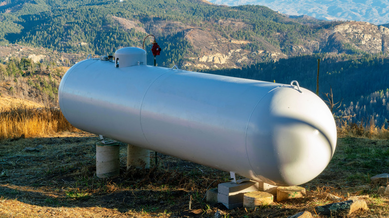 A white propane tank in shade