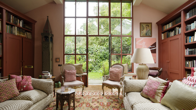 stylish traditional living room with millennial pink walls