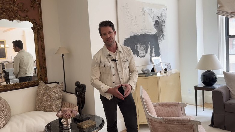 Nate Berkus standing in front of a decorated wall