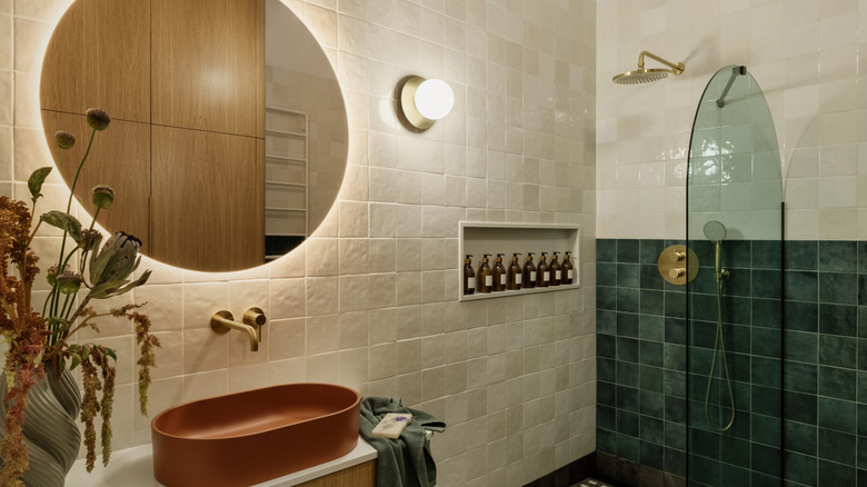 A bathroom with beige zellige tile walls