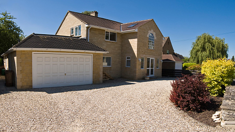 A well-maintained home with a gravel driveway