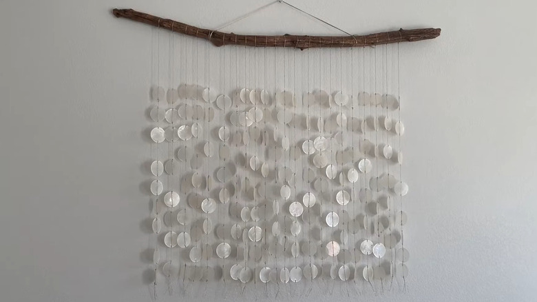 DIY wall art made from capiz shells and a branch