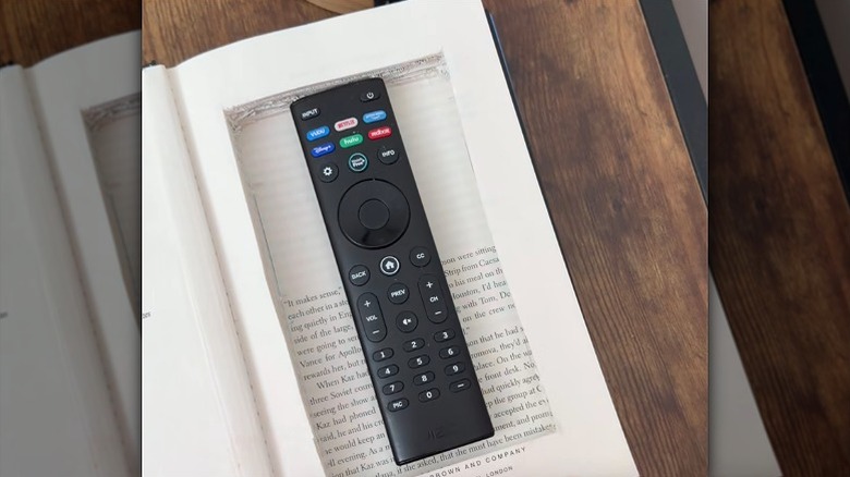 A DIY storage book concealing a TV remote