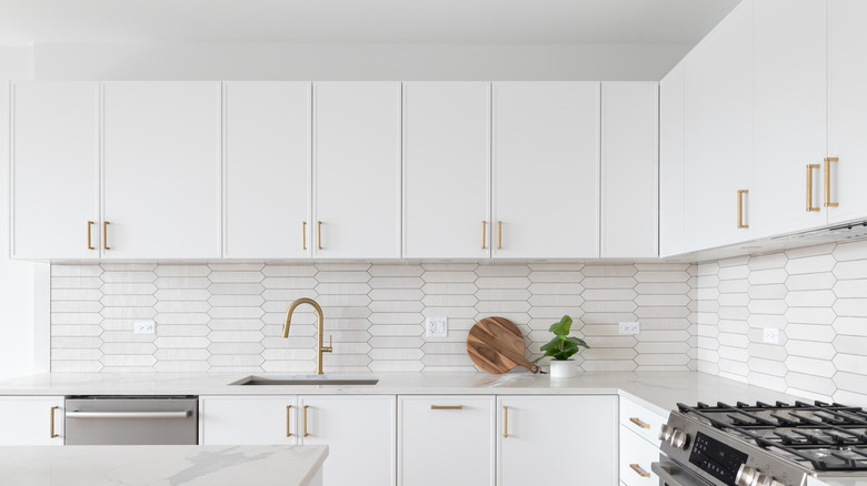 White kitchen cabinets with a gap between the ceiling