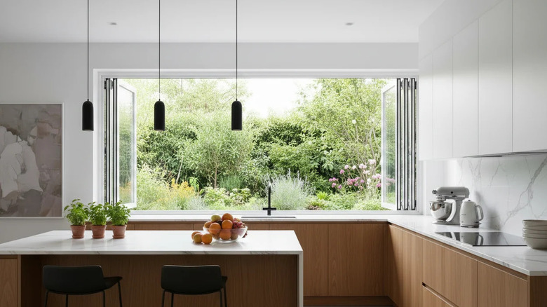 A modern kitchen with large collapsible window above the sink