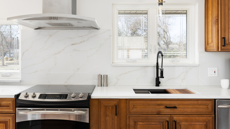 modern kitchen with honey oak cabinets and updated stone countertop