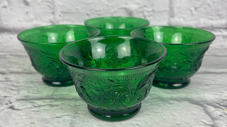 A collection of four green, depression-era, oatmeal box glass bowls