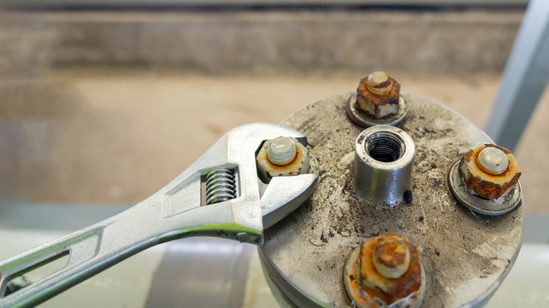 removing rusty bolts with a wrench