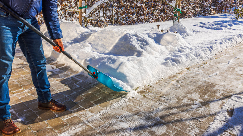Shoveling ice and snow from driveway