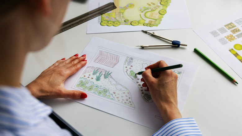 A landscape architect sketching a garden plan