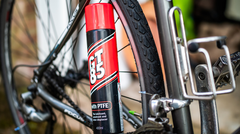 A can of GT85 on a bicycle wheel