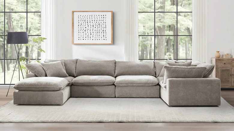 A large gray Sereen 6-piece Fabric Modular Sectional sits in front of two large windows