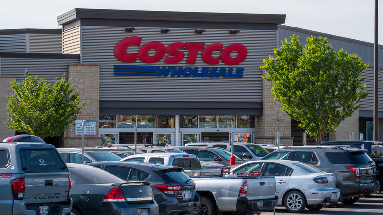 Cars parked outside of a crowded Costco