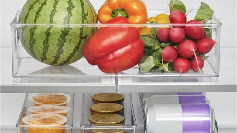 Fruit and vegetables and fruit cups and soda in organized clear bins