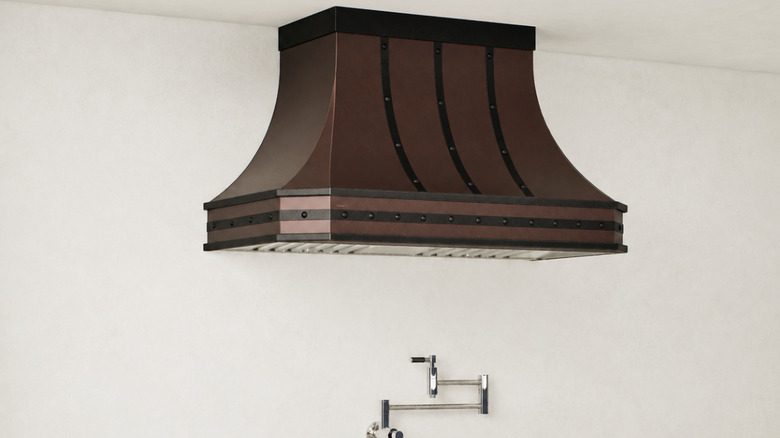 A luxury sculptural range hood in a kitchen