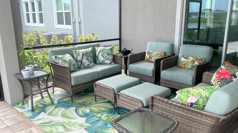 Beachy, tropical-style outdoor furniture arranged on a patio.