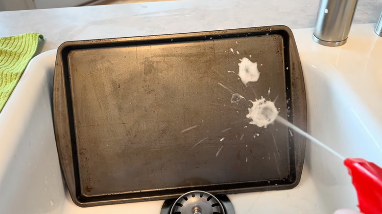 a baking sheet is sprayed with Brillo dishwashing spray