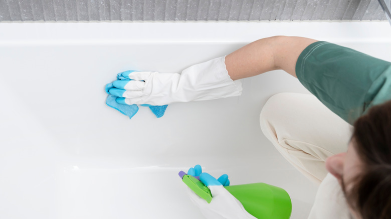Woman scrubbing a bathtub