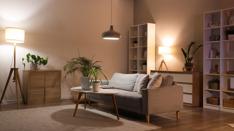 a neutral, modern living room with multiple accent lights