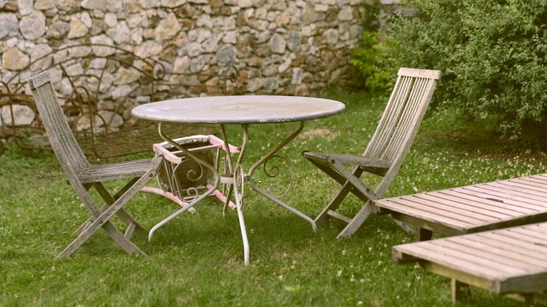 old lawn furniture in grass